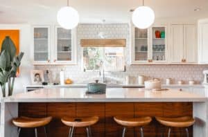 white marble kitchen island with brown bar stools