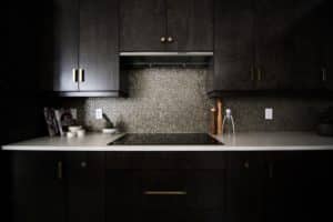 penny tile backsplash with dark cabinetry