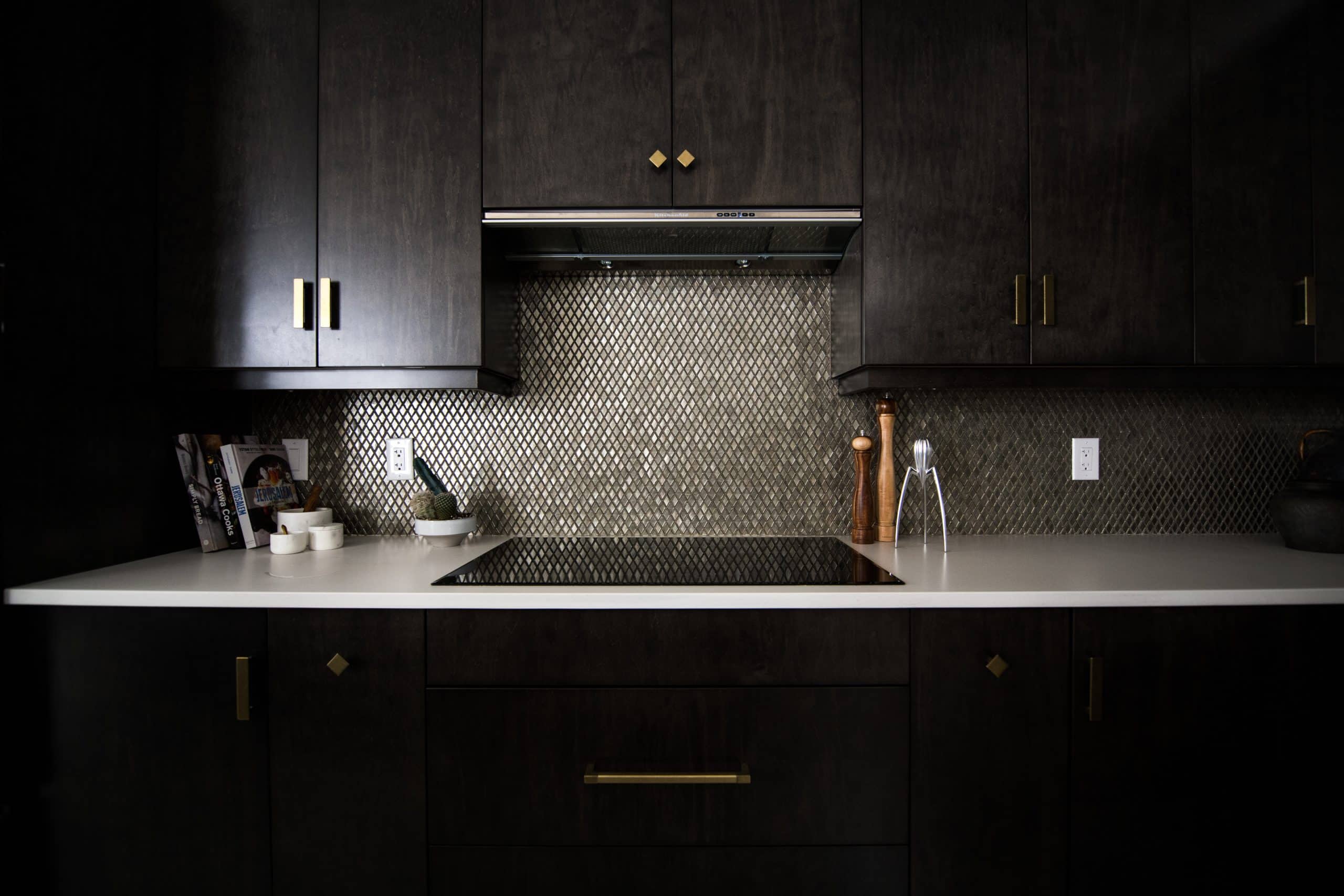 penny tile backsplash with dark cabinetry