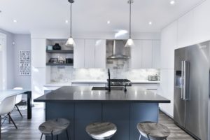 kitchen with black marble island top and white kitchen cabinets