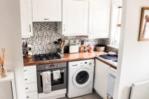 laundry room with white cabinets